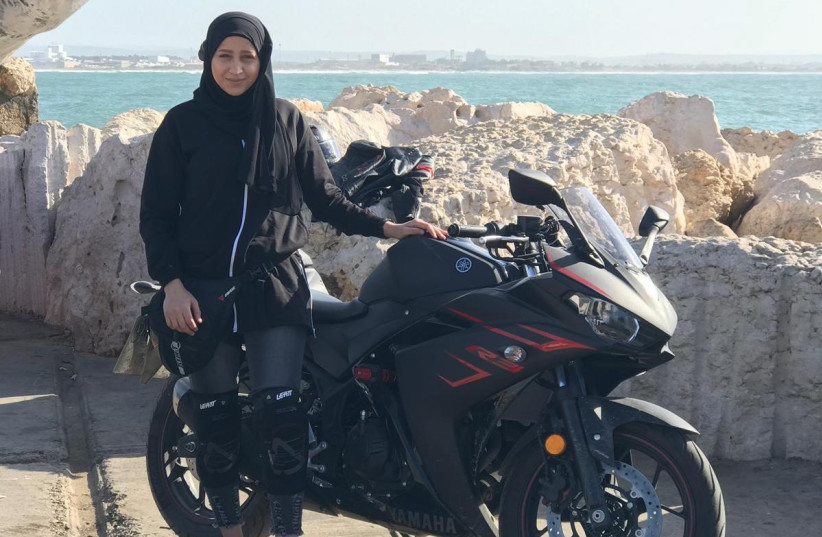 NERVANA ALI stops for a break on on a motorcycle ride around Acre's walls (photo credit: Courtesy)