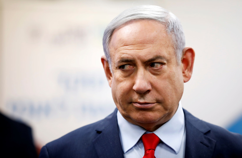 Israeli Prime Minister Benjamin Netanyahu looks on as he delivers a statement during his visit at the Health Ministry national hotline, in Kiryat Malachi, Israel March 1, 2020 (photo credit: AMIR COHEN/REUTERS)