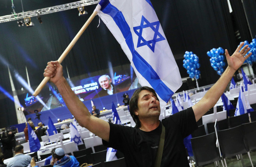 Likud supporters celebrate as the exit polls for Israel's March 2, 2020 elections are announced (photo credit: MARC ISRAEL SELLEM)