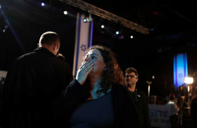 A supporter reacts as results of the exit polls are shown at Benny Gantz's Blue and White party headquarters, following Israel's national election, in Tel Aviv, Israel March 2 (photo credit: REUTERS/Ronen Zvulun)