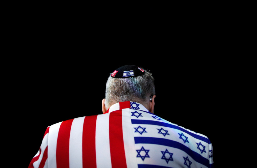A member of the audience looks on wearing a United States-Israel themed custom suit during the AIPAC convention at the Washington Convention Center in Washington, U.S., March 2, 2020. (credit: REUTERS/TOM BRENNER)