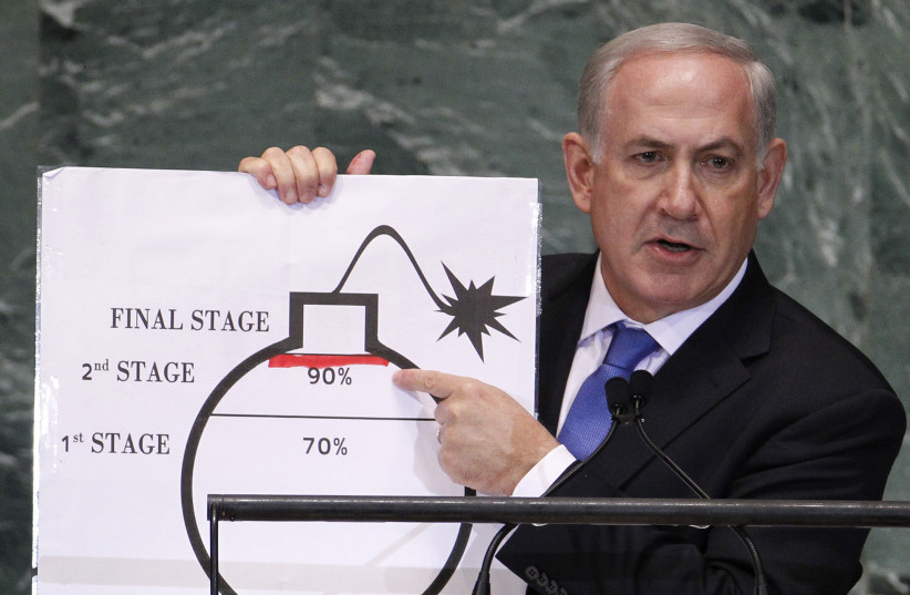 Israel's Prime Minister Netanyahu points to red line he drew on graphic of bomb used to represent Iran's nuclear program, in New York (photo credit: LUCAS JACKSON/REUTERS)
