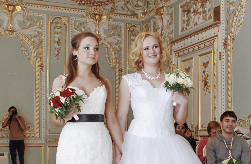 Two brides attend their wedding ceremony to each other at the wedding registry office in St. Petersburg (photo credit: REUTERS)
