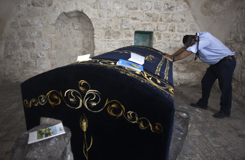 A Jewish worshipper policeman prays in Joseph's Tomb in the West Bank city of Nablus early July 4, 2011 (photo credit: REUTERS/NIR ELIAS)