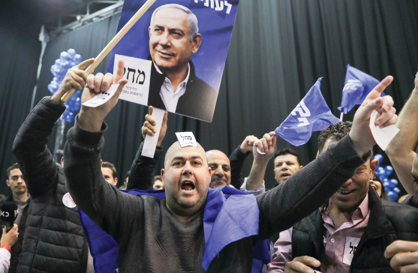 LIKUD SUPPORTERS celebrate the election results Monday night in Tel Aviv. (photo credit: MARC ISRAEL SELLEM/THE JERUSALEM POST)