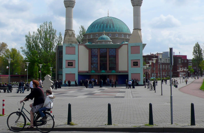 Cyclist passing by the Mevlana Mosque in Rotterdam, The Netherlands on May 2, 2008 (photo credit: RUUD ZWAT/WIKIMEDIA COMMONS/JTA)