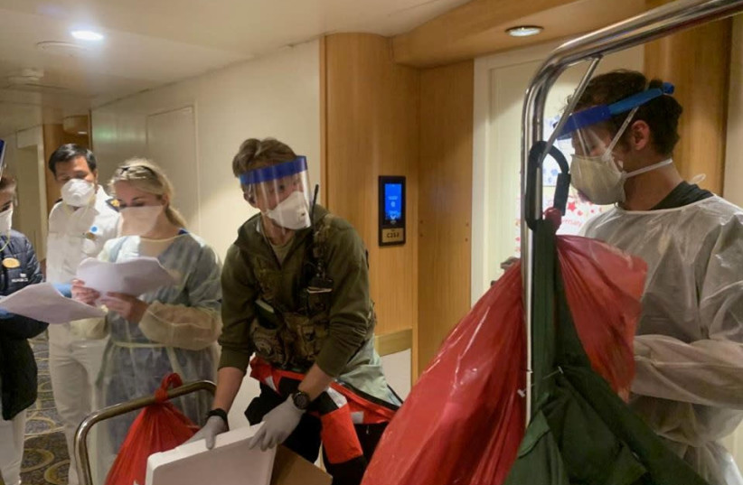 Medical personnel Guardian Angels with the 129th Rescue Wing, alongside individuals from the CDC don full personal protective equipment as they prepare to test travelers on the Grand Princess cruise ship for the coronavirus currently off the coast of California, U.S. in this handout photograph obtai (photo credit: NATIONAL GUARD/HANDOUT VIA REUTERS)