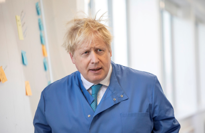 Britain's Prime Minister Boris Johnson visits the Mologic Laboratory in the Bedford Technology Park near Bedford, Britain March 6, 2020. (photo credit: JACK HILL/POOL VIA REUTERS)