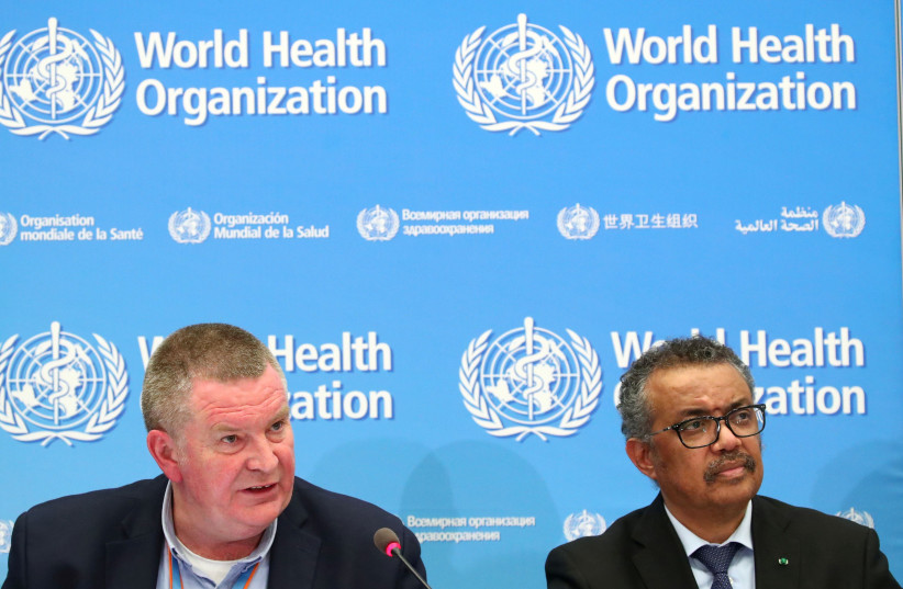 Michael J. Ryan, Executive Director of the WHO Health Emergencies Programme and Director-General of the WHO Tedros Adhanom Ghebreyesus, attend a news conference on the coronavirus (COVID-2019) (photo credit: REUTERS/DENIS BALIBOUSE)