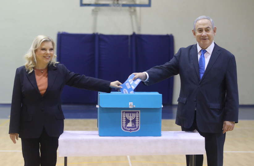 Prime Minister Benjamin Netanyahu and his wife Sara vote at a Jerusalem polling station on March 2  (photo credit: MARC ISRAEL SELLEM)