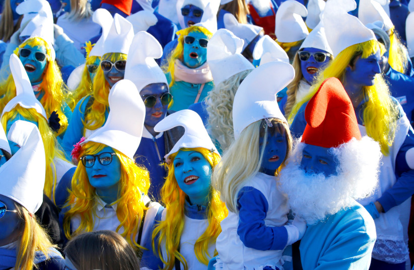 Participants dressed as smurfs celebrate after setting a new record for the world's largest meeting of smurfs in Lauchringen (photo credit: REUTERS/ARND WIEGMANN)