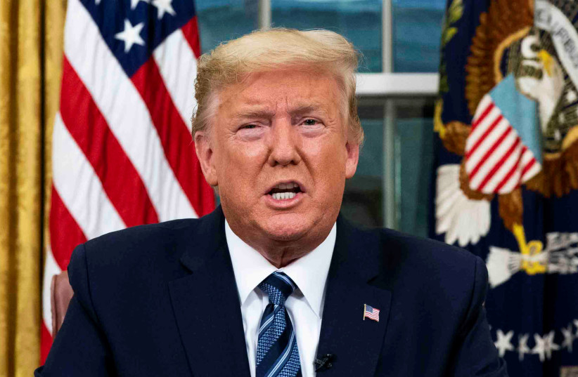 U.S. President Donald Trump speaks about the U.S response to the COVID-19 coronavirus pandemic during an address to the nation from the Oval Office of the White House in Washington, U.S., March 11, 2020 (photo credit: DOUG MILLS/POOL VIA REUTERS)