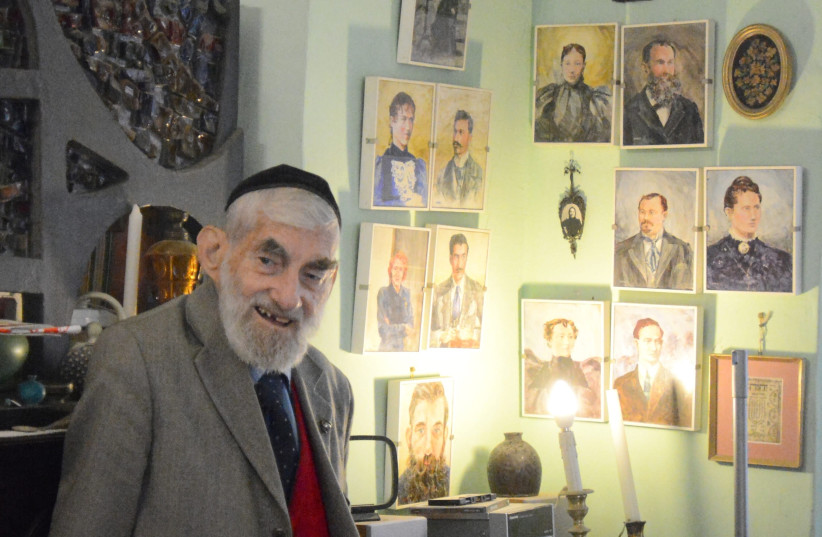 EZRA IN his one-room apartment in Nahalot, next to his portraits of his family. (photo credit: STUART GHERMAN)