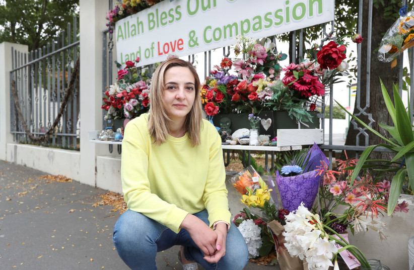 Aya Al-Umari, sister of mosque attack victim Hussein Al-Umari, poses outside Al Noor Mosque in advance of the anniversary of the mosque attacks that took place the prior year in Christchurch (photo credit: REUTERS/MARTIN HUNTER)