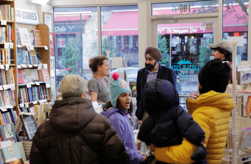 Hoboken, New Jersey Mayor-elect Ravi Bhalla speaks to customers as he arrives in a book store in Hoboken, New Jersey, US, November 9, 2017 (photo credit: REUTERS/LUCAS JACKSON)