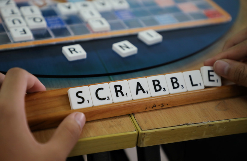 A player forms the word "Scrabble" with tiles during a practice session, in this posed picture taken in Kuala Lumpur, Malaysia, November 30, 2019 (photo credit: REUTERS/LIM HUEY TENG)