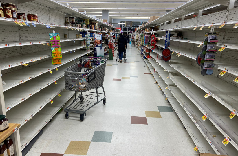 Household provisions are seeing in depleted quantities with nearly empty shelves at a department store in Washington, D.C., March 15, 2020 (photo credit: REUTERS/GAVINO GARAY)