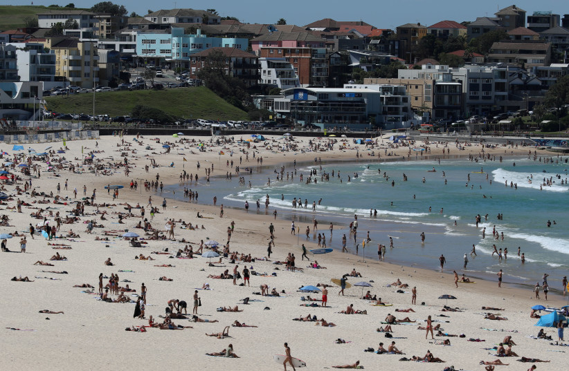 Beachgoers enjoy a sunny day at Bondi Beach despite growing concerns about the spread of the coronavirus disease (COVID-19) in Sydney (photo credit: REUTERS/LOREN ELLIOTT)