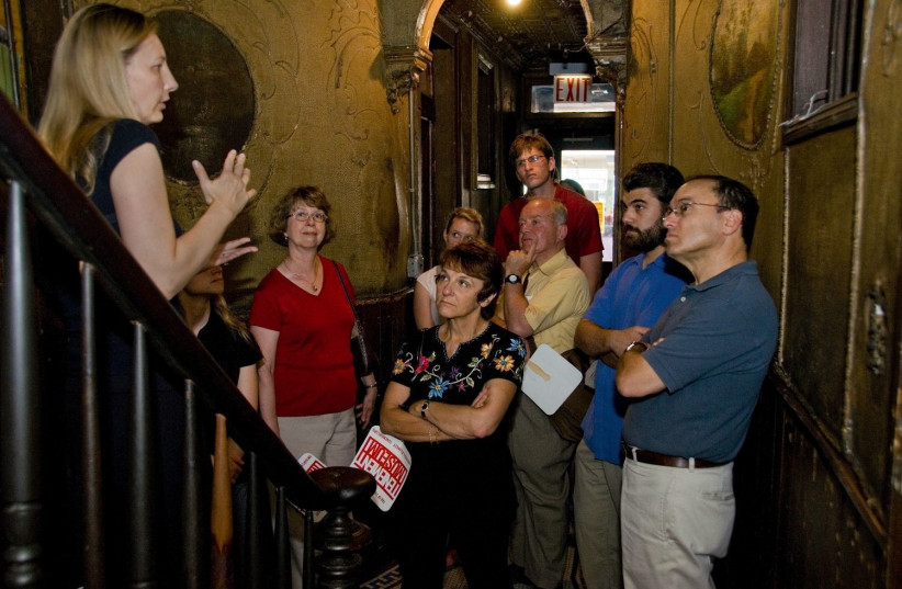 A group takes a tour of the Tenement Museum, which tells the stories of Jewish and other immigrants to New York. The museum has closed temporarily and shedded most of its staff. (photo credit: COURTESY OF THE TENEMENT MUSEUM)