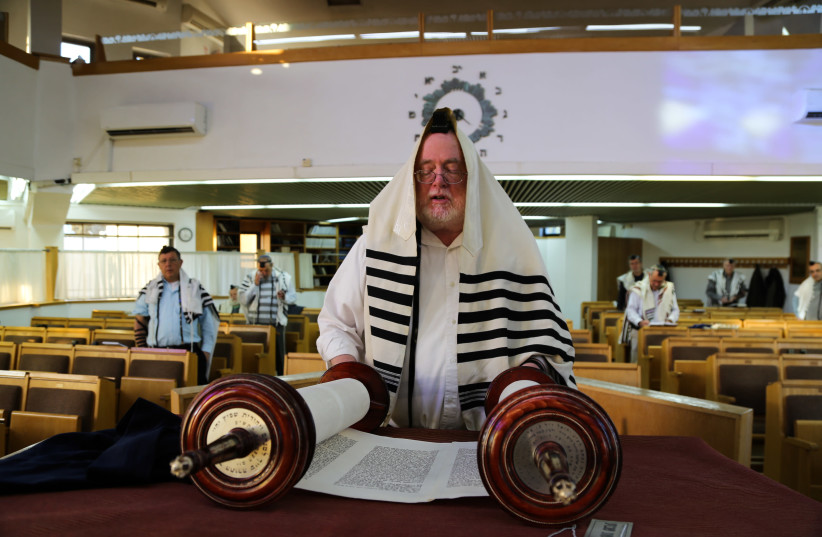 Jewish men attend morning prayer as they keeping distance from one another as part of measures to prevent the spread of the Coronavirus, at a synagogue in the Jewish settlement of Efrat, in Gush Etzion (photo credit: GERSHON ELINSON/FLASH90)