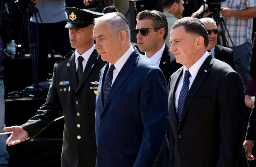 PRIME MINISTER Benjamin Netanyahu walks ahead of Knesset Speaker Yuli Edelstein at the annual Holocaust Remembrance Day ceremony at Yad Vashem in 2018.  (photo credit: DEBBIE HILL/REUTERS)