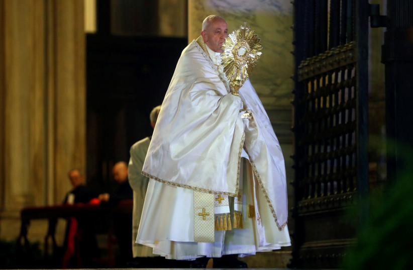 Pope Francis is pictured at St. Peter's Basilica during an extraordinary "Urbi et Orbi" (to the city and the world) blessing - normally given only at Christmas and Easter -, as a response to the global coronavirus disease (COVID-19) pandemic, at the Vatican, March 27, 2020 (photo credit: REUTERS/YARA NARDI/POOL)