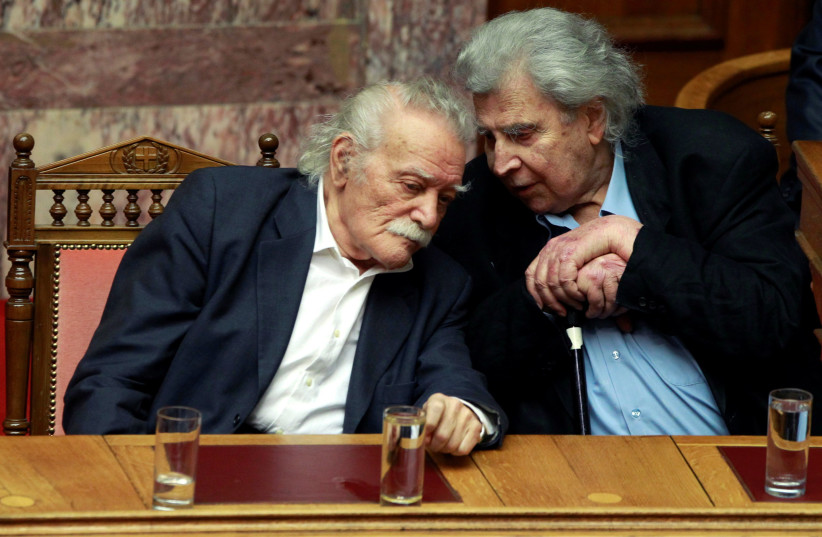 Famous composer Mikis Theodorakis (R) and veteran leftist politician Manolis Glezos watch a parliament session prior to a vote for a new austerity deal in Athens February 12, 2012.  (photo credit: JOHN KOLESIDIS/REUTERS)