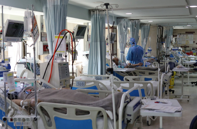 Patients with coronavirus disease (COVID-19) lie in beds at the ICU of Sasan Hospital, in Tehran, Iran March 30, 2020 (credit: WANA (WEST ASIA NEWS AGENCY)/ALI KHARA VIA REUTERS)