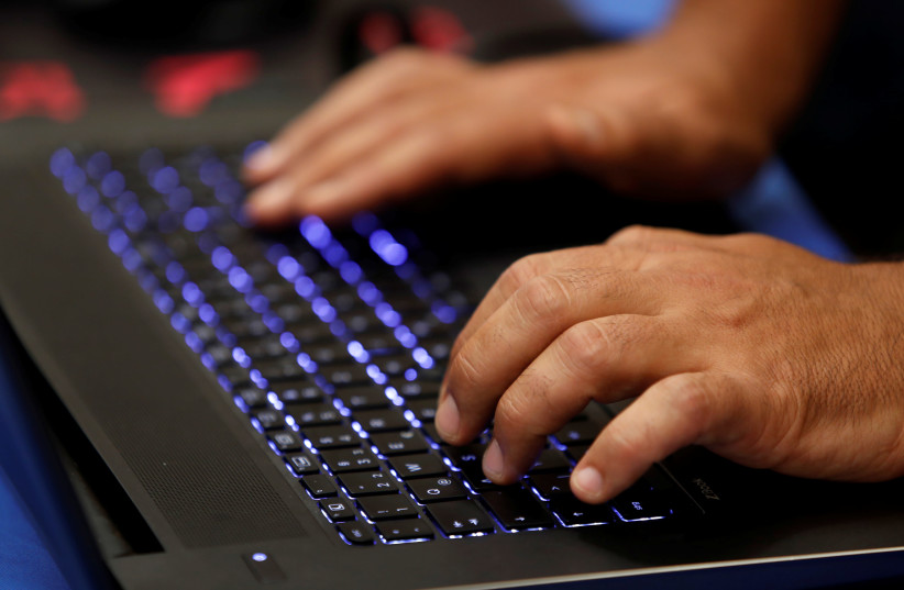 A man types into a keyboard during the Def Con hacker convention in Las Vegas, Nevada, U.S. (photo credit: REUTERS/STEVE MARCUS)