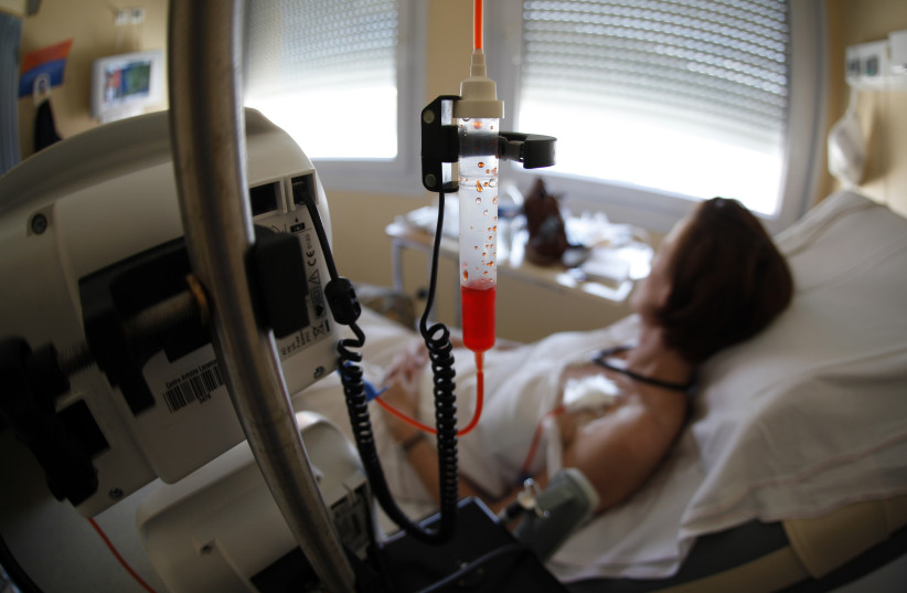 A patient receives chemotherapy treatment for breast cancer (photo credit: REUTERS/ERIC GAILLARD)