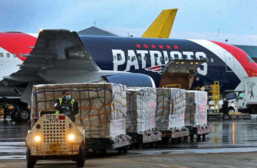 A New England Patriots Boeing 767-300 jet with a shipment of over one million N95 masks from China, which will be used in Boston and New York to help fight the spread of the coronavirus disease (COVID-19), arrives at Logan Airport, Boston, Massachusetts, U.S., April 2, 2020 (photo credit: JIM DAVIS/POOL VIA REUTERS)
