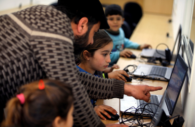 Children attend computer lessons in an educational center in the Bedouin village of Al-Maleh in Jordan Valley (photo credit: REUTERS/RANEEN SAWAFTA)
