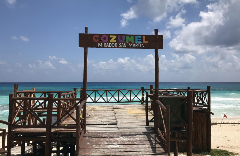 A BEACH ON Cozumel island in Quintana Roo State, Mexico, is empty last week. (photo credit: DANIEL SLIM/AFP VIA GETTY IMAGES/TNS)