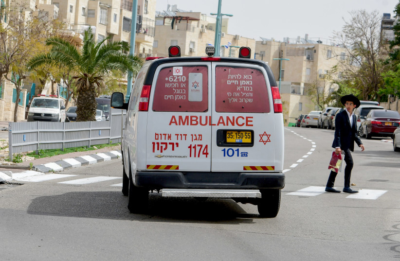 An ambulance driving in the central Israeli city of Elad, April 5, 2020 (photo credit: AVSHALOM SASSONI/FLASH90)