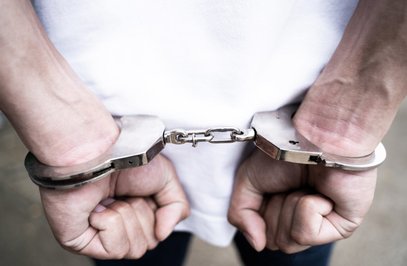 Male hands arrested with handcuffs in Criminal concept (illustrative) (photo credit: INGIMAGE)