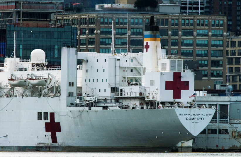 The USNS hospital ship Comfort is seen docked at Pier 90 on Manhattan's West Side as the outbreak of the coronavirus disease (COVID-19) continues in New York City (photo credit: EDUARDO MUNOZ / REUTERS)
