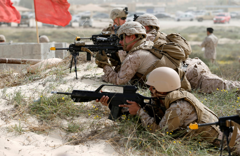 U.S. Navy Marines and Saudi Navy Special Force personnel take their positions during mixed maritime exercise with U.S. Navy and Saudi Royal Navy, at Saudi Military Port, Ras Al Ghar, Eastern Province, in Jubail, Saudi Arabia February 26, 2020. (photo credit: HAMAD I MOHAMMED / REUTERS)