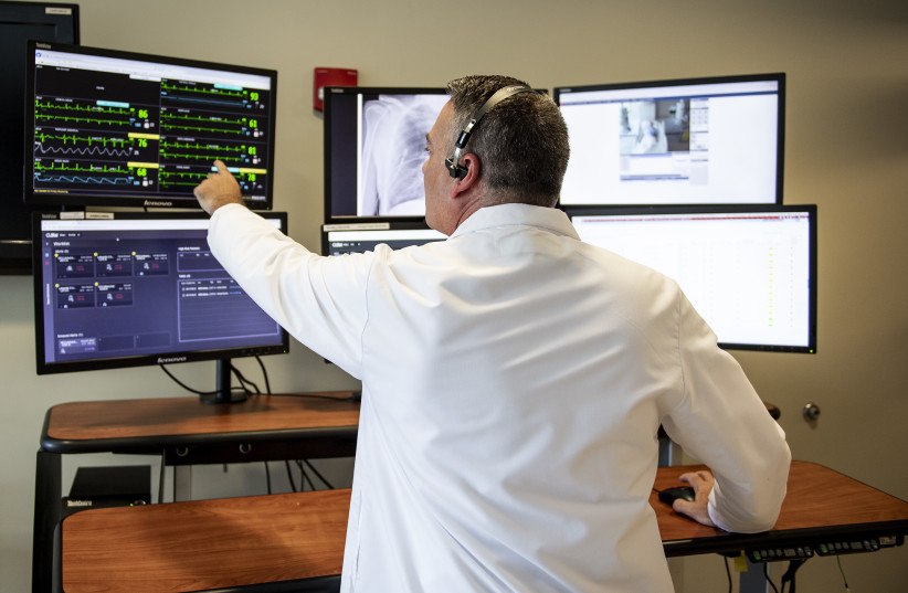 A HEALTHCARE worker checks on patients remotely by using CLEW Medical’s AI-based technology.  (photo credit: CLEW MEDICAL)