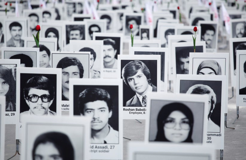 A memorial exhibition featuring Iranian political prisoners and organised by opposition group the People's Mujahedin of Iran is seen on the Esplanade des Invalides in Paris, France, October 29, 2019 (photo credit: BENOIT TESSIER/REUTERS)