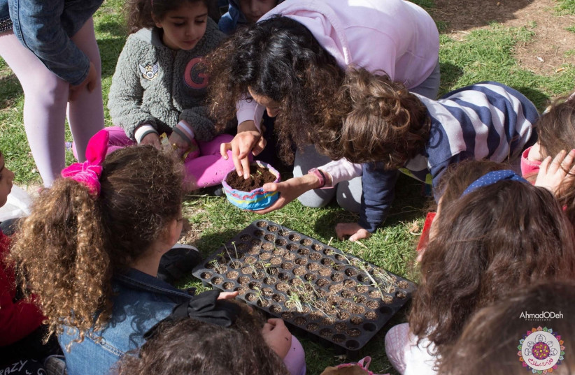 Salam Al Bandak works with children during an outdoor workshop. (photo credit: SALAM AL BANDAK)