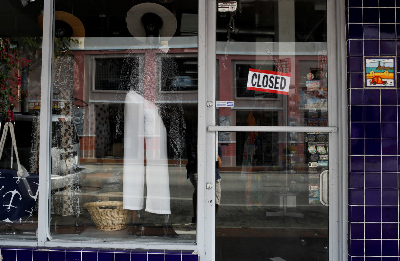 A closed notice is seen on the door of a store at Little Havana neighborhood, as the spread of the coronavirus disease (COVID-19) continues, in Miami, Florida, U.S. (photo credit: REUTERS/MARCO BELLO)
