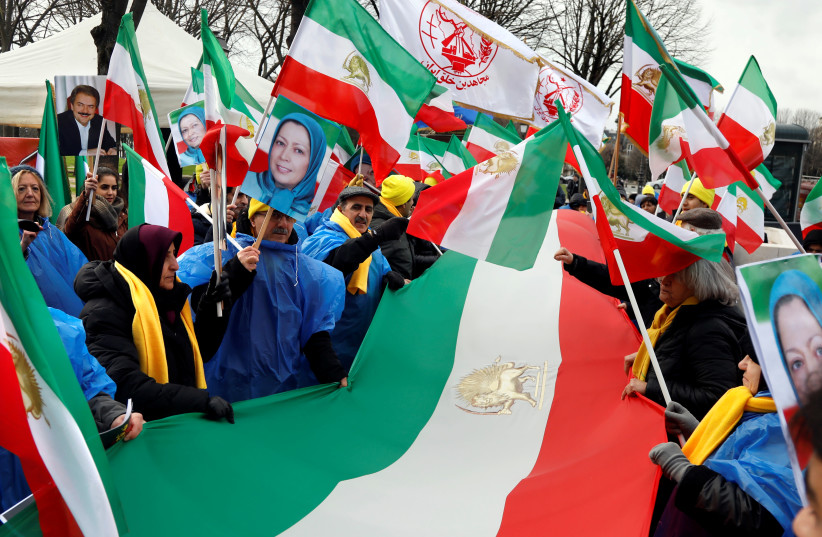 ranian opponents-in-exile hold pictures and "Lion and Sun" pre-Iranian Revolution national flags as they stage a protest against the Tehran government and mark the 41st anniversary of the Islamic revolution, in Paris, France, February 11, 2020. (photo credit: REUTERS)