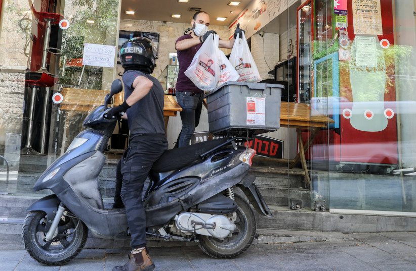 Restaurants switch from in-house eating to food delivery due to the coronavirus. (photo credit: MARC ISRAEL SELLEM)