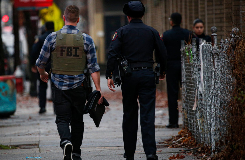 A FBI officer arrives at the scene of an active shooting in Jersey City, N.J., Dec. 10, 2019. (photo credit: KENA BETANCUR/GETTY IMAGES/AFP)