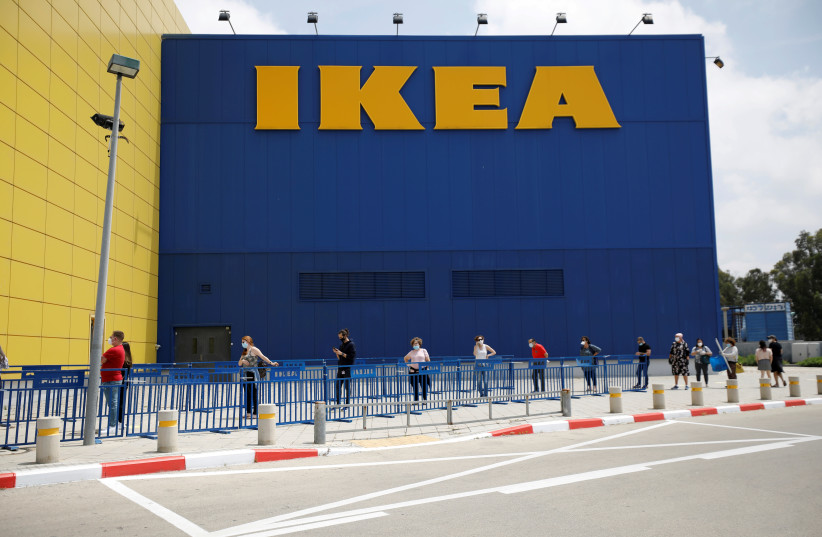 Customers wait outside an IKEA shop after the coronavirus disease (COVID-19) lockdown has been eased around the country and the company opens some of its stores, in Netanya, Israel April 23, 2020 (photo credit: REUTERS/AMIR COHEN)