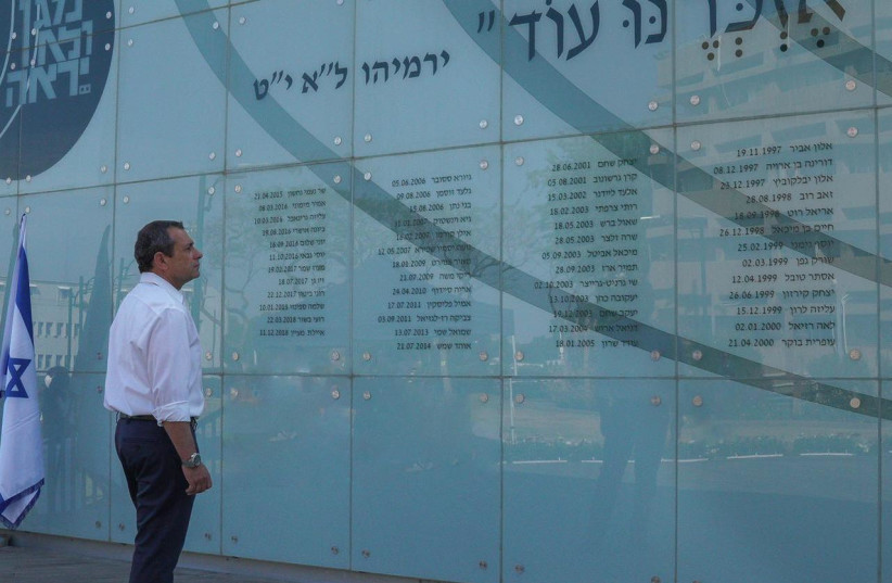 Shin Bet Chief Nadav Argaman stands in front of the wall of fallen servicepeople at Shin Bet headquarters. (photo credit: SHIN BET)