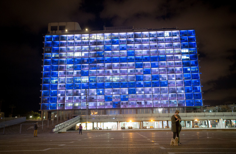 The Israeli flag is displayed on the Tel Aviv municipality building on Rabin Square, as Israel celebrates it's 72th Independence Day under lockdown due to the Coronavirus. April 28, 2020 (photo credit: MIRIAM ALSTER/FLASH90)