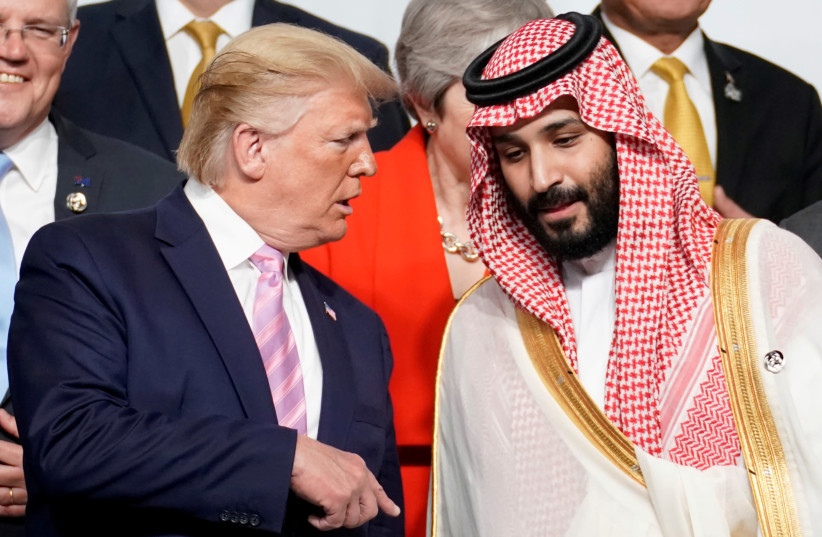  FILE PHOTO: U.S. President Donald Trump speaks with Saudi Arabia's Crown Prince Mohammed bin Salman during photo session with other leaders and attendees at the G20 leaders summit in Osaka, Japan, June 28, 2019 (photo credit: REUTERS/KEVIN LAMARQUE/FILE PHOTO)