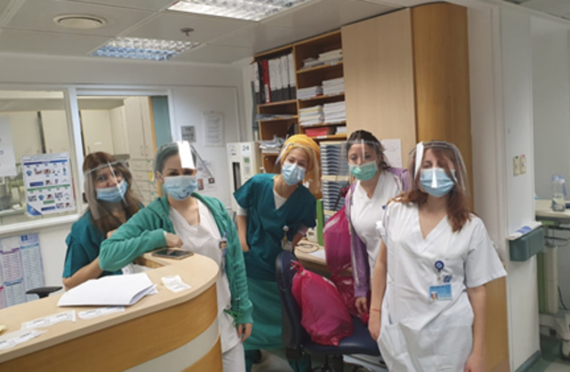 Medical staff of the Department of Cardiology, Hadassah Ein Kerem wearing face shields designed by students of Bezalel Academy of Arts and Design, Jerusalem (credit: Courtesy)
