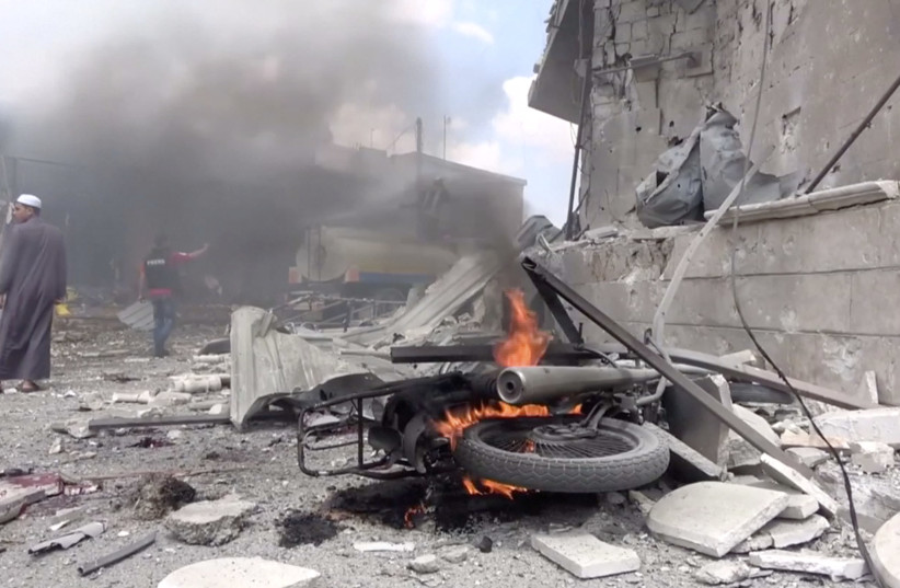 A motorbike burns after an airstrike in this screen grab taken from a social media video said to be taken in Idlib, Syria on July 16, 2019 (photo credit: WHITE HELMETS/SOCIAL MEDIA VIA REUTERS)